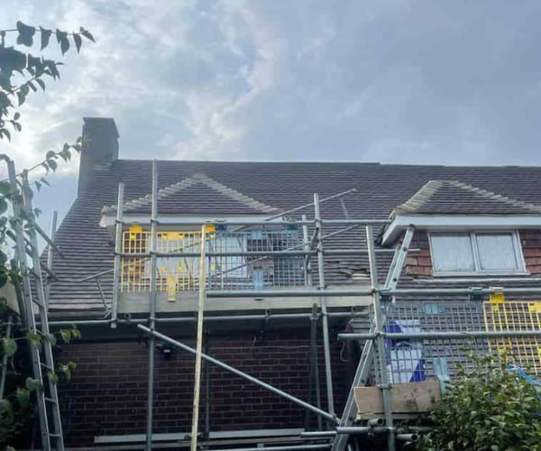 This is a photo of a roof with two dormers that is having some damaged tiles replaced. Works carried out by KAD Roofing Bircotes.