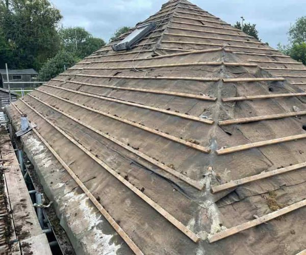 This is a photo of a hip roof that has been stripped back to the battens, and is awaiting a new roof covering to be installed. Works carried out by KAD Roofing Bircotes